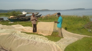 Okello and Lwanga mending a net